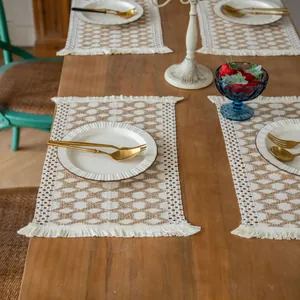 Elegant rustic farmhouse woven placemats with fringe detail on wooden dining table