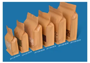 Macro view of kraft paper stand-up pouches with windows in various sizes.