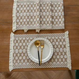 Detailed overhead view of a woven farmhouse placemat with geometric patterns and tassels.