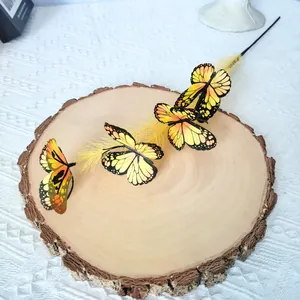 Detail of artificial yellow butterflies on a floral branch stem for home decor.