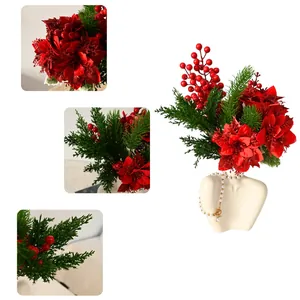 Close-up of glittery red poinsettias and pine branches in a Christmas flower bundle