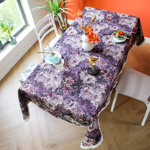 Detailed shot of thick purple floral jacquard tablecloth with refined white tassel edge trim