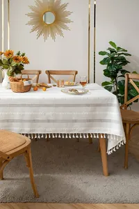 Vintage white cotton linen tablecloth with embroidery and tassel details in lifestyle setting