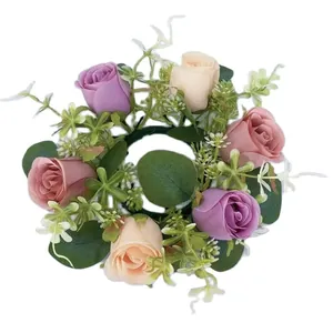 Close-up top view of artificial eucalyptus candle ring decorated with colorful roses