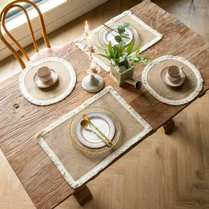 Professional set of farmhouse jute placemats with white fringe on a rustic wooden table