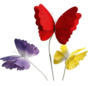Detail shot of decorative mesh butterflies in red, purple, and yellow for weddings.