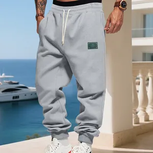 Casual grey fleece joggers for men featuring a loose fit drawstring waist in an outdoor setting
