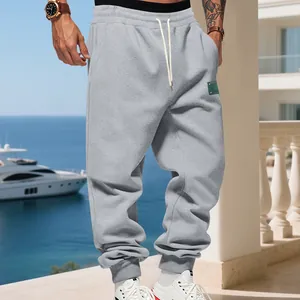Men's grey fleece-lined joggers featuring a drawstring waist and stylish elastic ankle cuffs