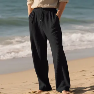 Detail of men's black ribbed wide-leg pants with drawstring and textured stripe