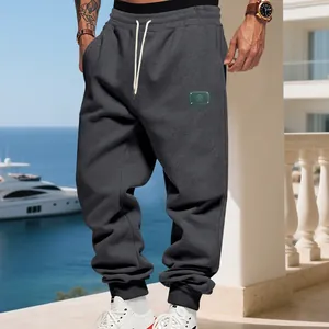 Detailed view of men's loose fleece joggers in charcoal grey with drawstring waist