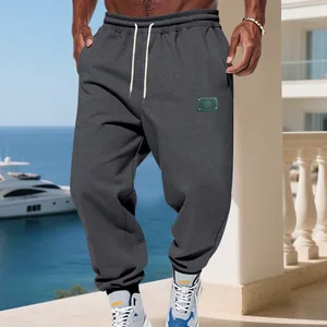 Men's loose dark gray fleece joggers with drawstring waist and elastic ankle cuffs