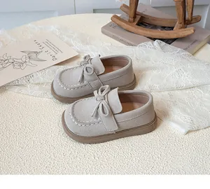 Detailansicht grauer Kleinkinder-Loafer mit dekorativer Schleife und weißen Nähten