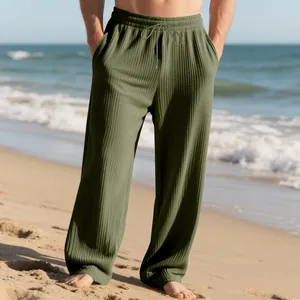 Close-up of green ribbed texture on men's drawstring wide-leg casual pants.