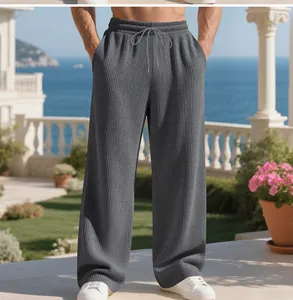 Macro view of men's grey ribbed wide-leg pants featuring a comfortable drawstring waist.