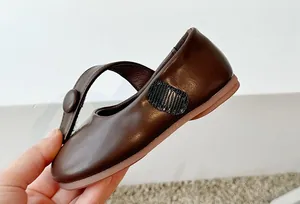 Detailed view of elegant dark brown soft-sole Mary Jane princess shoes for girls