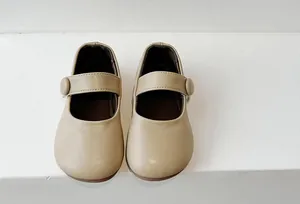 Top view of beige soft sole Mary Jane princess shoes for girls with button strap