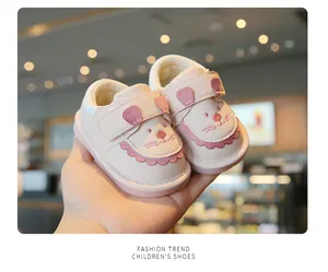 Nahaufnahme von rosa Lauflernschuhen für Kleinkinder mit niedlichem Katzen-Design.