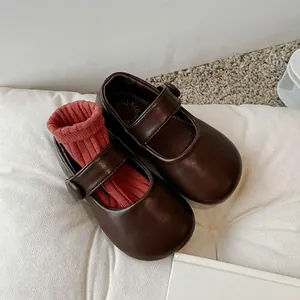 Classic dark brown Mary Jane shoes for girls featuring soft soles and a strap design