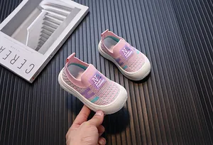 Detailed view of pink breathable knit kids sneakers featuring comfortable soft white soles