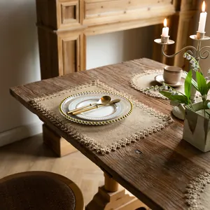 Rustic farmhouse jute placemat with elegant fringe detail on a vintage wooden dining table