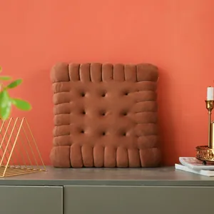 Detailed view of a soft brown biscuit-shaped plush cushion resting on a stylish sideboard