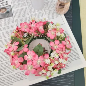 Detailed close-up of a pink wild flower wreath used as a candle ring for home table decoration