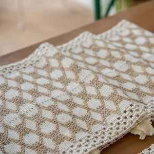 Close-up of farmhouse woven cotton linen placemat with diamond pattern and tassel detail