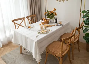 Vintage white cotton linen tablecloth with elegant hollow-out embroidery and tassels.