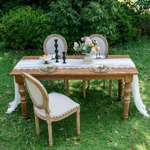 Elegant white lace table runner for outdoor wedding party decoration on wooden dining table