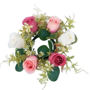 Close-up top view of decorative artificial rose and eucalyptus candle ring wreath for tables