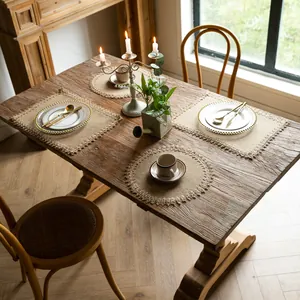 Detailed scene of rustic jute placemats with fringe and braided edges on wooden table
