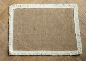 Detailed texture view of a rectangular jute placemat with farmhouse white fringe border.