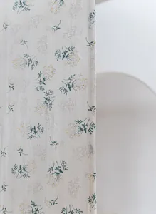 Detailed view of minimalist floral print on vintage-style cotton door curtain fabric