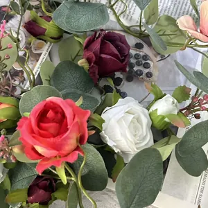 Close-up detail of artificial French rose flowers and eucalyptus leaf vine decoration