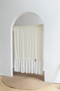Fresh style cream door curtain with orange dots and white ruffled bottom detail.
