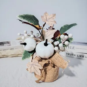 Rustic artificial white pumpkin arrangement with maple leaves and berries in burlap wrap