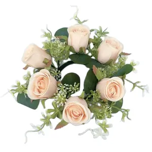 Macro view of artificial rose candle ring with eucalyptus leaves and small flowers
