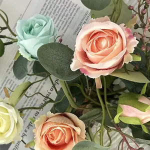 Macro view of high simulation French roses and eucalyptus leaves on a vintage newspaper