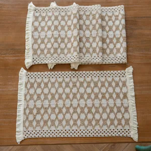 Detailed view of woven cotton linen placemat with geometric pattern and ivory fringe
