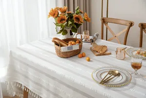 White retro rural cotton linen tablecloth with fringe in a dining room setting