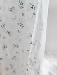 Close-up of retro floral cotton door curtain showing delicate pattern and fabric texture.