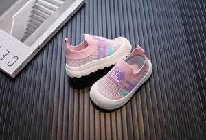Close-up of pink breathable fly-knit children's sneakers with soft white soles
