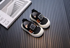 Detailed view of breathable fly-knit children's sneakers with soft rubber soles.