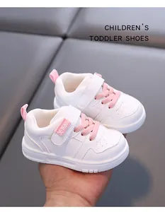 Close-up of white and pink toddler walking shoes with soft anti-slip soles