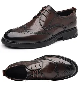 Detailed close-up view of brown genuine leather brogue dress shoes with crocodile texture.