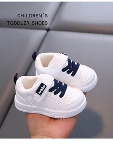 Durable white microfiber leather toddler shoes with navy blue laces and Velcro strap