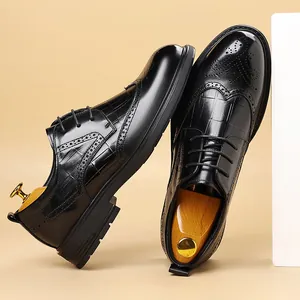 Classic black leather Brogue dress shoes for men with intricate carved wingtip details.