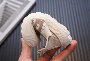 Close-up of flexible breathable flyknit sneakers for toddlers with soft nonslip sole
