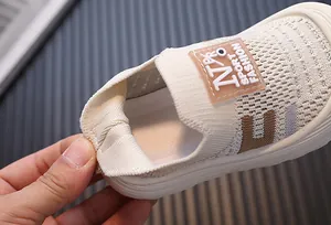 Detailed close-up of the breathable fly-knit mesh and soft heel of kids' sneakers