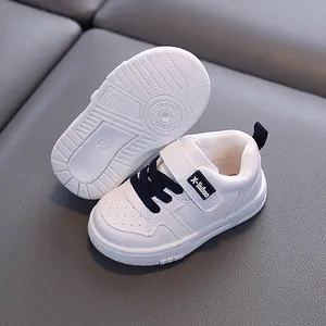 White baby walking shoes with waterproof micro-fiber leather and non-slip soft soles.